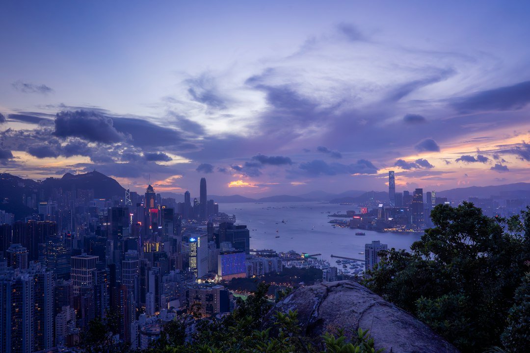 Vibrant cityscape and harbor at sunset with dramatic clouds
